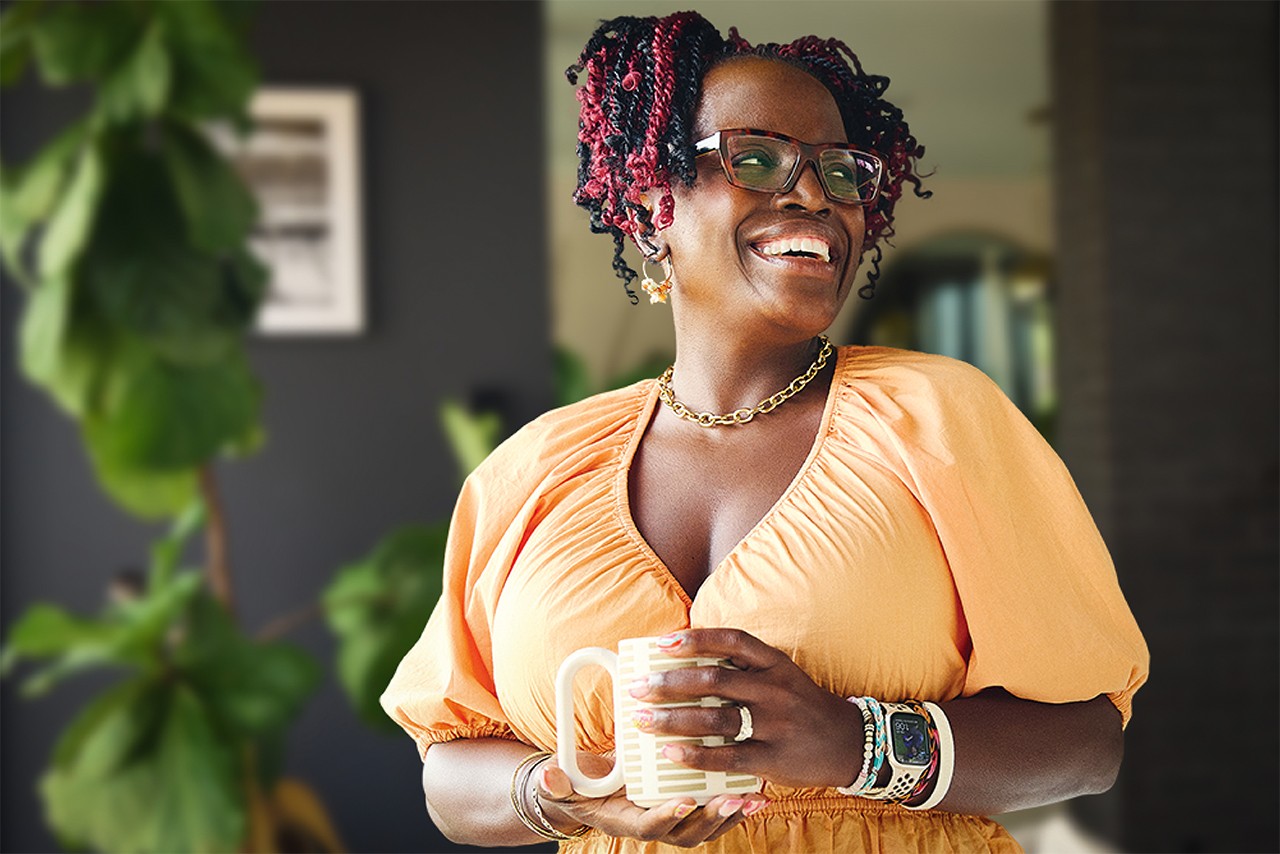Eboni Walker holding beverage and smiling