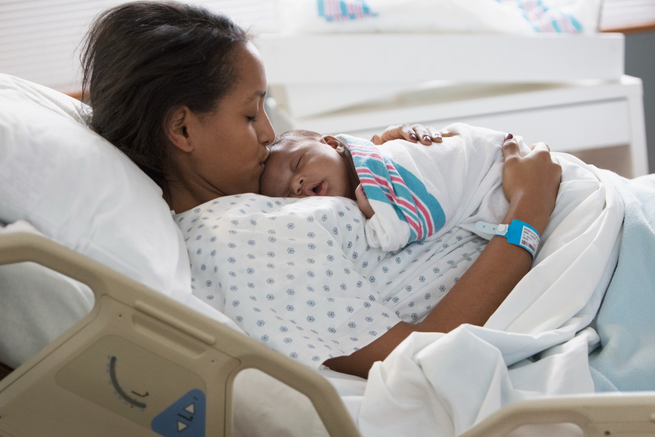 mom holding newborn in the hospital
